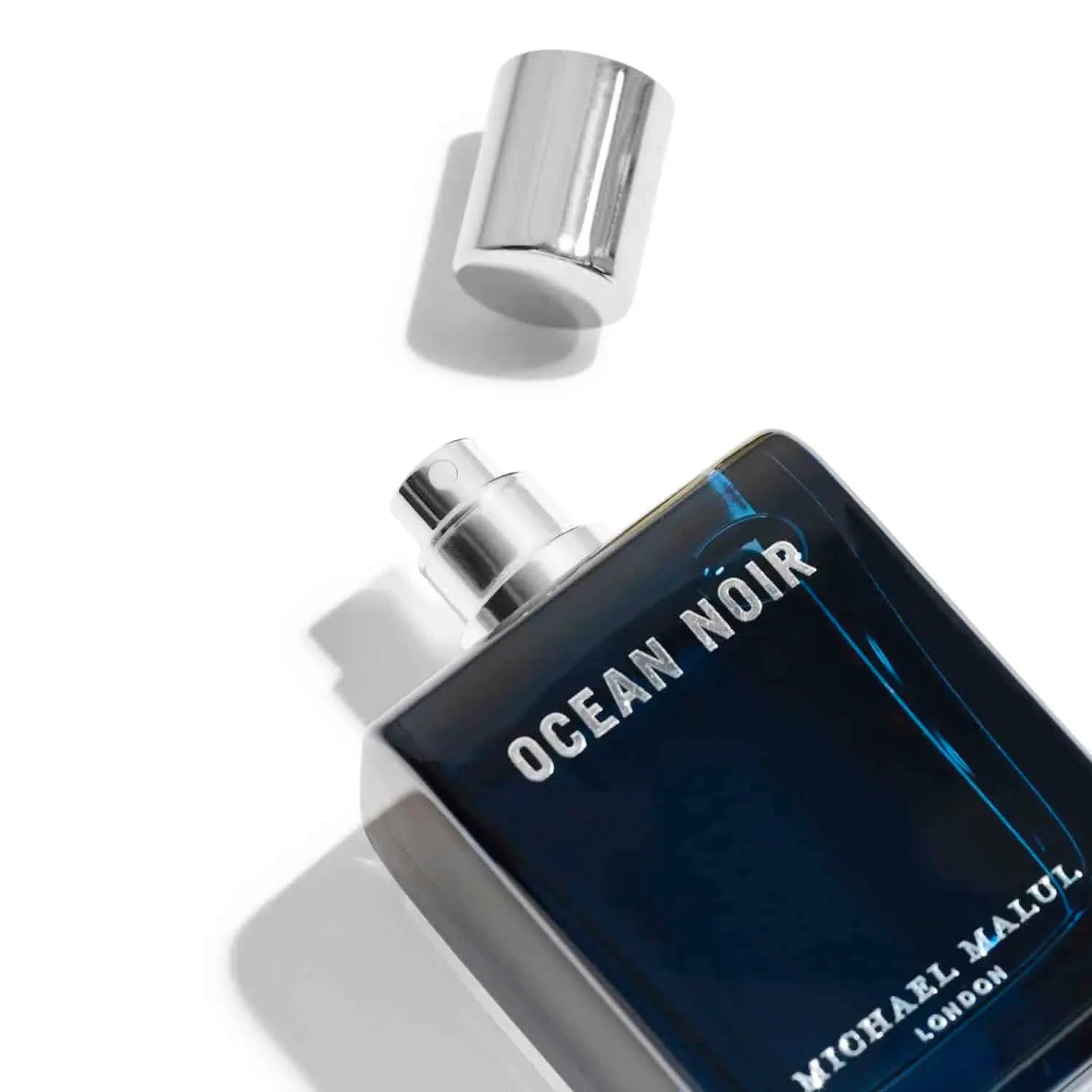 Close-up spray of Ocean Noir perfume on skin